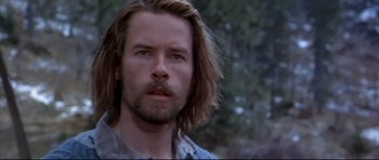 Movie still from “Ravenous” (1999), directed by Antonia Bird – A person with long hair and a beard; Close Up shot, Low angle