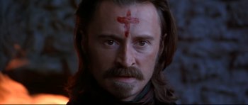 Movie still from “Ravenous” (1999), directed by Antonia Bird – A person with a cross on his forehead; Close Up shot, High angle