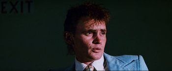 Movie still from “Razorback” (1984), directed by Russell Mulcahy – A person wearing a suit and tie; Close Up shot, Low angle