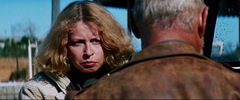 Movie still from “Razorback” (1984), directed by Russell Mulcahy – A person talking to another person; Close Up shot, Over the shoulder angle