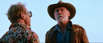 Movie still from “Razorback” (1984), directed by Russell Mulcahy – A man in a cowboy hat is looking at the sky; Close Up shot, Low angle