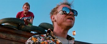 Movie still from “Razorback” (1984), directed by Russell Mulcahy – A person wearing sunglasses; Close Up shot, Low angle