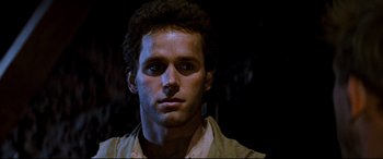 Movie still from “Razorback” (1984), directed by Russell Mulcahy – A person wearing a shirt; Close Up shot, Low angle