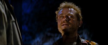 Movie still from “Razorback” (1984), directed by Russell Mulcahy – A person with a blonde mohawk; Close Up shot, Low angle