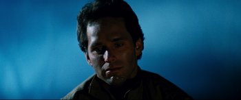 Movie still from “Razorback” (1984), directed by Russell Mulcahy – A person wearing a brown shirt; Close Up shot, Low angle