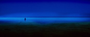 Movie still from “Razorback” (1984), directed by Russell Mulcahy – A view of a body of water at night time; Extreme Wide shot, High angle