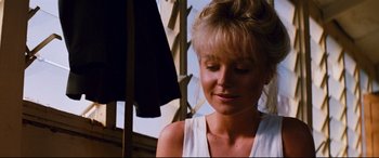 Movie still from “Razorback” (1984), directed by Russell Mulcahy – A woman in a white shirt is looking down; Close Up shot, Low angle