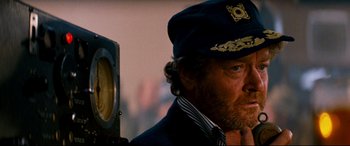 Movie still from “Razorback” (1984), directed by Russell Mulcahy – A person wearing a hat; Close Up shot, Over the shoulder angle