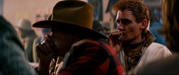 Movie still from “Razorback” (1984), directed by Russell Mulcahy – Two men are talking on their cell phones; Close Up shot, Over the shoulder angle