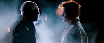 Movie still from “Razorback” (1984), directed by Russell Mulcahy – Two people face to face in a foggy night; Close Up shot, Low angle
