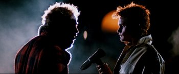 Movie still from “Razorback” (1984), directed by Russell Mulcahy – Two people are holding a blow dryer in their hands; Close Up shot, Low angle