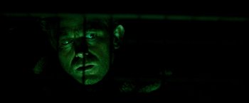 Movie still from “Razorback” (1984), directed by Russell Mulcahy – A person's face in the dark; Close Up shot, Low angle