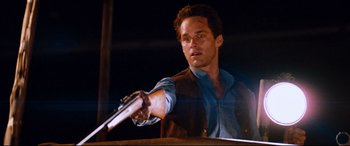 Movie still from “Razorback” (1984), directed by Russell Mulcahy – A man holding a gun in his right hand; Close Up shot, Low angle