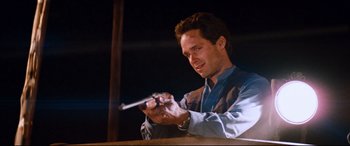 Movie still from “Razorback” (1984), directed by Russell Mulcahy – A man is holding something in his hands; Close Up shot, Low angle