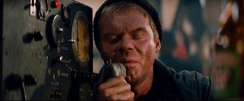 Movie still from “Razorback” (1984), directed by Russell Mulcahy – A person holding a cell phone; Close Up shot, Low angle