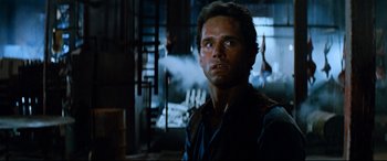 Movie still from “Razorback” (1984), directed by Russell Mulcahy – A man in a room with smoke coming out of a window; Close Up shot, Low angle