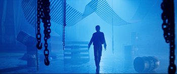 Movie still from “Razorback” (1984), directed by Russell Mulcahy – A man walking in a room filled with fog; Wide shot, Low angle