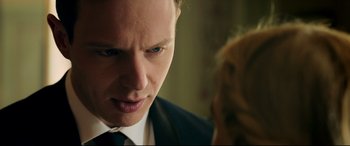 Movie still from “Ready or Not” (2019), directed by Matt Bettinelli-Olpin – A person wearing a suit and tie; Close Up shot, Over the shoulder angle