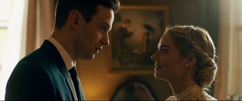 Movie still from “Ready or Not” (2019), directed by Matt Bettinelli-Olpin – A man and a woman looking at each other in front of a painting; Close Up shot, Low angle