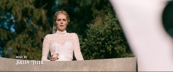 Movie still from “Ready or Not” (2019), directed by Matt Bettinelli-Olpin – A woman in a white dress holding a glass of wine; Medium shot, Low angle