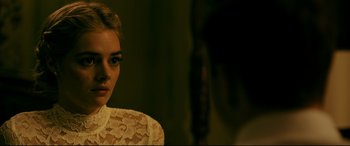 Movie still from “Ready or Not” (2019), directed by Matt Bettinelli-Olpin – A woman in a white lace dress looking at the camera; Close Up shot, Over the shoulder angle
