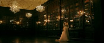 Movie still from “Ready or Not” (2019), directed by Matt Bettinelli-Olpin – A woman in a long white dress standing in a room; Wide shot, Low angle