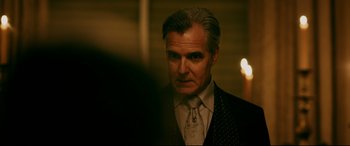 Movie still from “Ready or Not” (2019), directed by Matt Bettinelli-Olpin – A person wearing a suit and tie; Close Up shot, Over the shoulder angle