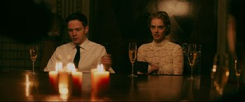 Movie still from “Ready or Not” (2019), directed by Matt Bettinelli-Olpin – A man and a woman sitting in front of candles; Medium shot, Over the shoulder angle