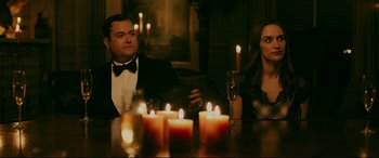 Movie still from “Ready or Not” (2019), directed by Matt Bettinelli-Olpin – A man and a woman sitting at a table with candles; Medium shot, Over the shoulder angle