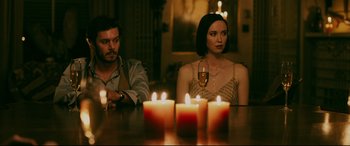 Movie still from “Ready or Not” (2019), directed by Matt Bettinelli-Olpin – A man and a woman sitting in front of candles; Medium shot, Over the shoulder angle