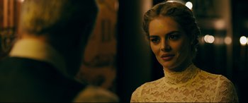 Movie still from “Ready or Not” (2019), directed by Matt Bettinelli-Olpin – A woman in a white lace dress looking at the camera; Close Up shot, Over the shoulder angle