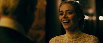 Movie still from “Ready or Not” (2019), directed by Matt Bettinelli-Olpin – A beautiful young lady wearing a white lace dress; Close Up shot, Over the shoulder angle