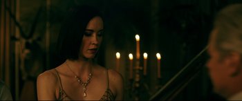 Movie still from “Ready or Not” (2019), directed by Matt Bettinelli-Olpin – A beautiful woman wearing a necklace in front of candles in a dark room; Close Up shot, Over the shoulder angle