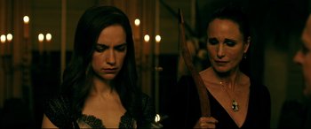 Movie still from “Ready or Not” (2019), directed by Matt Bettinelli-Olpin – A woman holding a bow and arrow next to another woman; Close Up shot, Over the shoulder angle