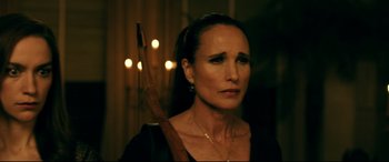 Movie still from “Ready or Not” (2019), directed by Matt Bettinelli-Olpin – A person holding a bow and arrow; Close Up shot, Over the shoulder angle