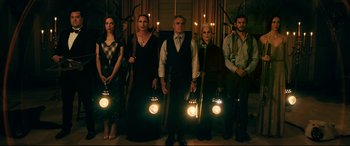Movie still from “Ready or Not” (2019), directed by Matt Bettinelli-Olpin – A group of people standing next to each other holding lights; Wide shot, Low angle