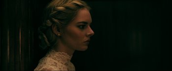 Movie still from “Ready or Not” (2019), directed by Matt Bettinelli-Olpin – A beautiful woman with blonde hair wearing a white dress; Close Up shot, Over the shoulder angle