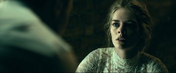 Movie still from “Ready or Not” (2019), directed by Matt Bettinelli-Olpin – A woman in a white lace top looking at the camera; Close Up shot, Over the shoulder angle