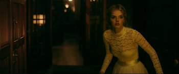 Movie still from “Ready or Not” (2019), directed by Matt Bettinelli-Olpin – A beautiful young lady wearing a white dress; Medium shot, Over the shoulder angle