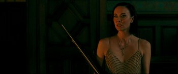 Movie still from “Ready or Not” (2019), directed by Matt Bettinelli-Olpin – A woman holding a pool cue in a dark room; Close Up shot, Over the shoulder angle