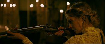 Movie still from “Ready or Not” (2019), directed by Matt Bettinelli-Olpin – A woman is holding a gun in her hand; Close Up shot, Over the shoulder angle