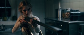 Movie still from “Ready or Not” (2019), directed by Matt Bettinelli-Olpin – A woman is holding a rifle in a room; Medium shot, Over the shoulder angle