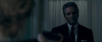 Movie still from “Ready or Not” (2019), directed by Matt Bettinelli-Olpin – A man wearing a suit and tie in front of a mirror; Close Up shot, Over the shoulder angle