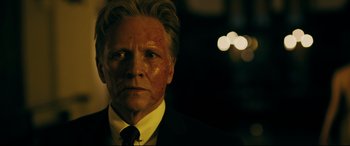 Movie still from “Ready or Not” (2019), directed by Matt Bettinelli-Olpin – A person wearing a suit and tie; Close Up shot, Low angle