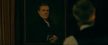 Movie still from “Ready or Not” (2019), directed by Matt Bettinelli-Olpin – A painting of an older man holding a book in front of a mirror; Close Up shot, Over the shoulder angle