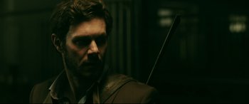 Movie still from “Ready or Not” (2019), directed by Matt Bettinelli-Olpin – A person wearing a suit and tie; Close Up shot, Over the shoulder angle