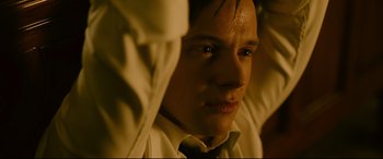 Movie still from “Ready or Not” (2019), directed by Matt Bettinelli-Olpin – A young man in a white shirt and a black tie; Close Up shot, High angle