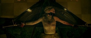 Movie still from “Ready or Not” (2019), directed by Matt Bettinelli-Olpin – A woman with a black tape around her mouth; Medium shot, Overhead angle