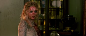 Movie still from “Ready or Not” (2019), directed by Matt Bettinelli-Olpin – A woman with red makeup on her face; Close Up shot, Over the shoulder angle