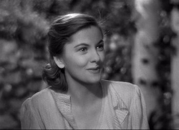 Movie still from “Rebecca” (1940), directed by Alfred Hitchcock – A black - and - white photo of a young woman; Close Up shot, Over the shoulder angle